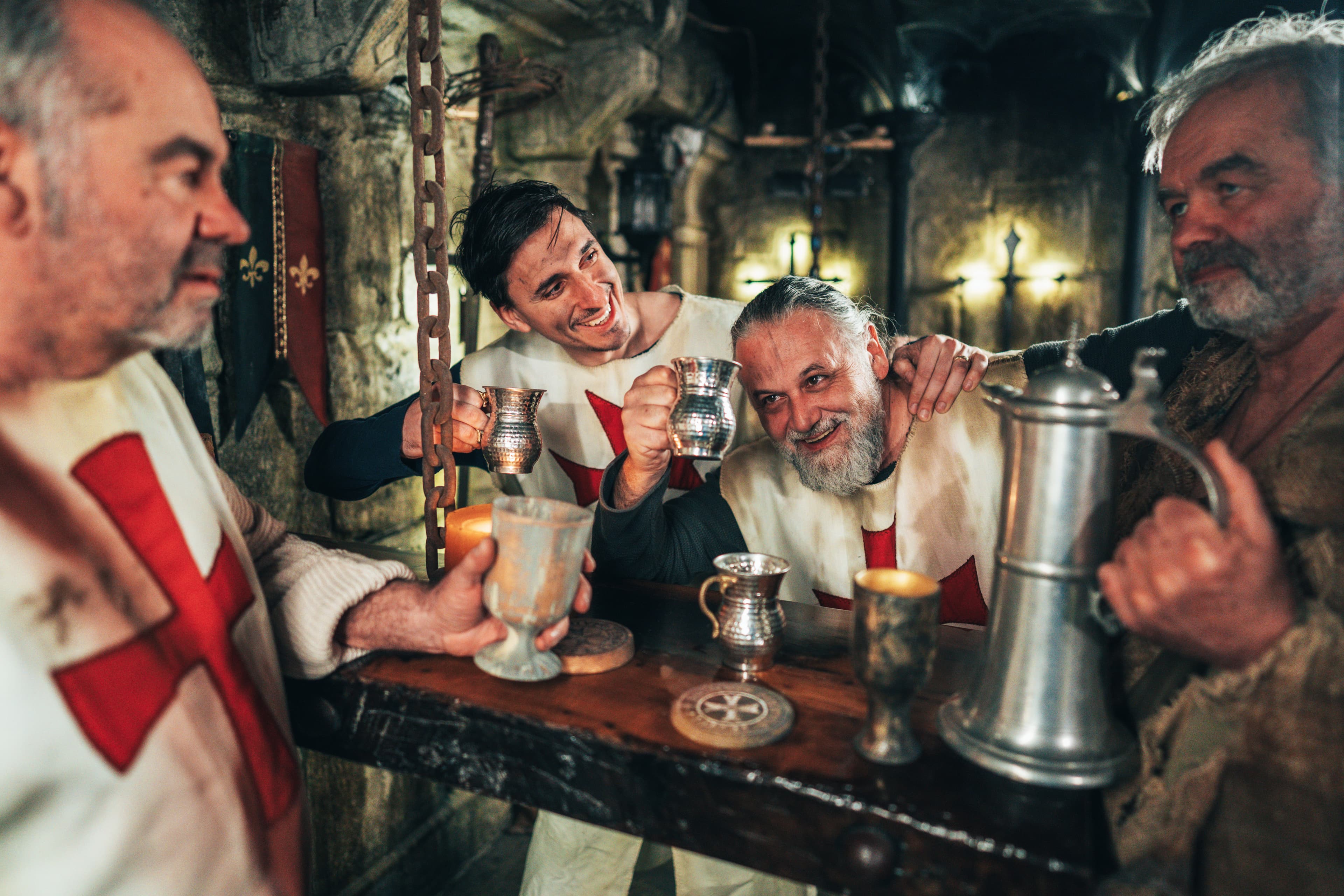 A team celebrating together with metal tankards in the bar