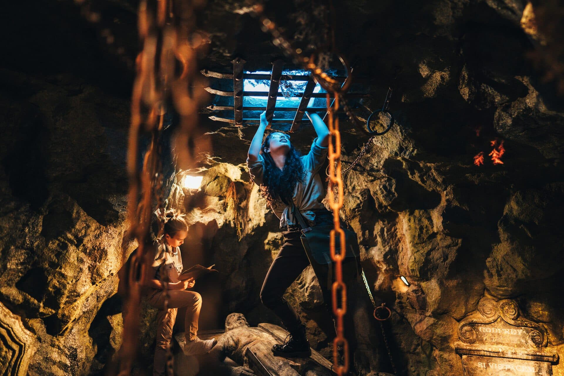 Team members solving a mechanical puzzle in The Lost Ark